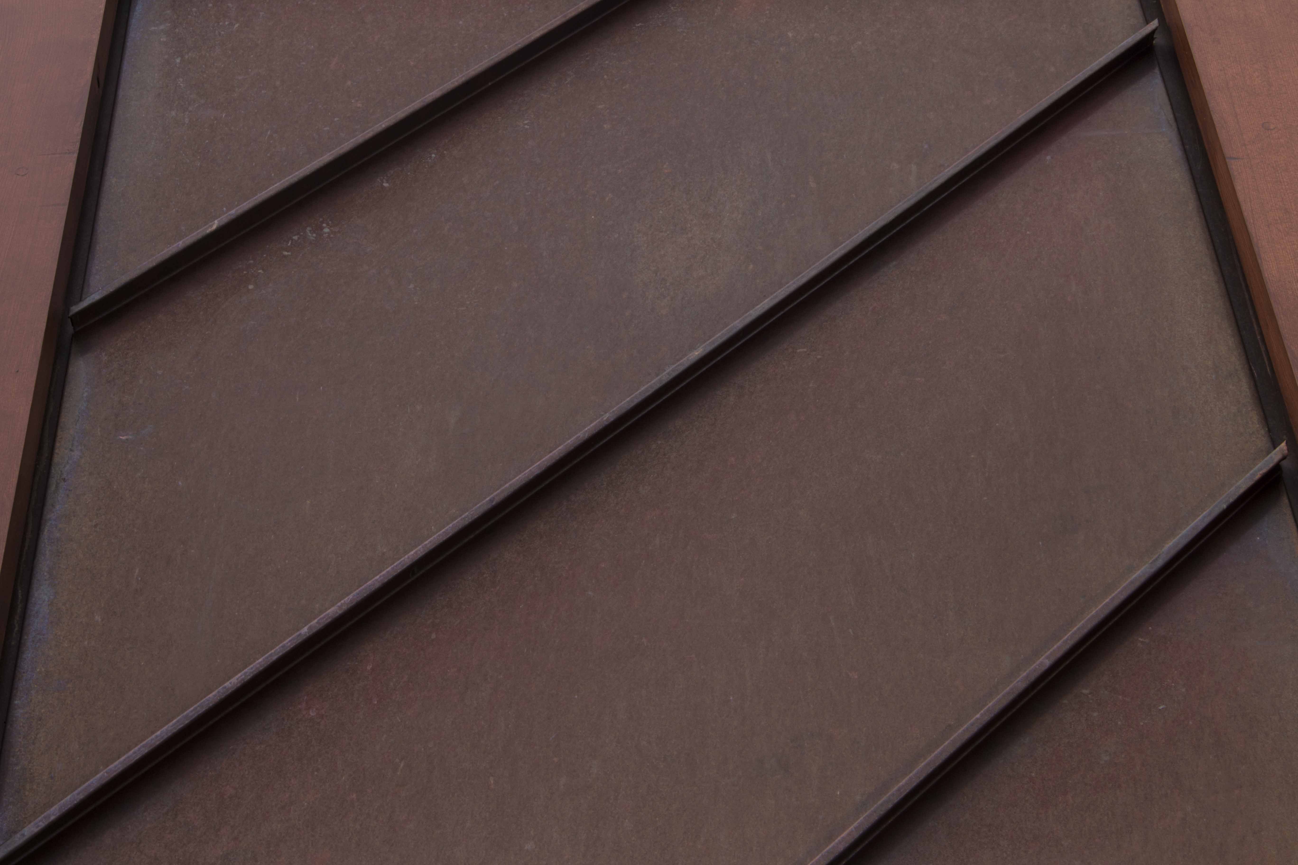 Natural copper cladding in a standing seam profile.
